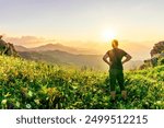 man doing hiking sport in mountains with anazing highland view, happy person watching amazing highland evening sunset, person delight with nature landscape