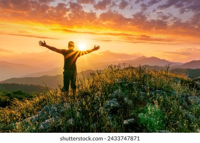 man doing hiking sport in mountains with anazing highland view, sportsman person does hike sport in a mountain walley with beautiful sunset on background - Powered by Shutterstock