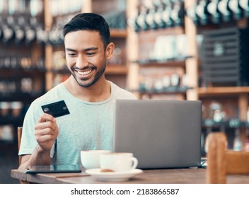 Man Doing Online Shopping, Purchase Or Loan With Credit Card And Laptop At An Internet Cafe. Young Happy Male Paying Off Insurance Debt On A Digital Banking App With Modern Tech And Looking