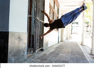 Man doing parkour in the city on a sunny day - Powered by Shutterstock