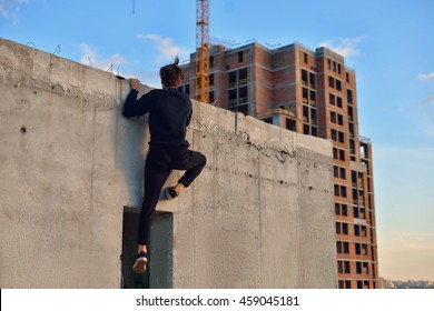 Man Doing Parkour In The City On The Roof