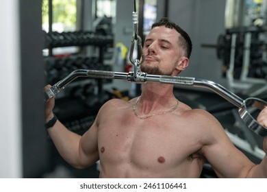 Man doing pull downs at the gym