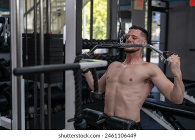 Man doing pull downs at the gym