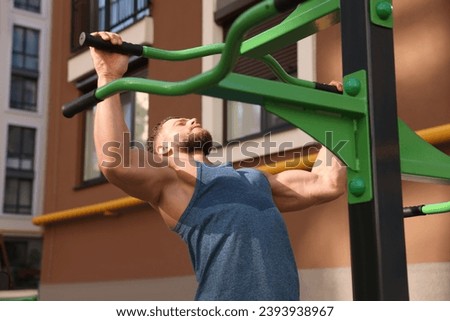 Man doing pull ups at outdoor gym