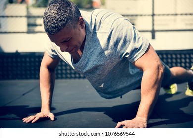 Man doing a push up - Powered by Shutterstock