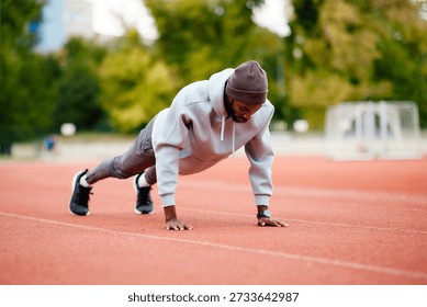 Man doing push up exercise on outdoor track
