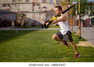 Man Doing Push Ups Exercise With Trx Fitness Straps. Outdoor, Workout, Training, Lifestyle Concept .