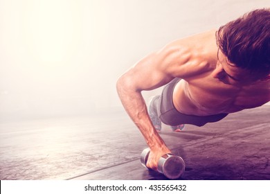 Man Doing Push-up Exercise With Dumbbell