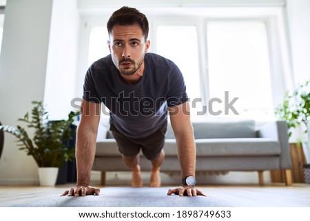 Man doing pushup exercise during home workout.