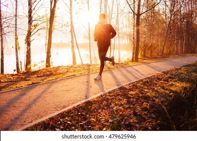 Man Doing Running Exercise At Autumn, Winter Morning