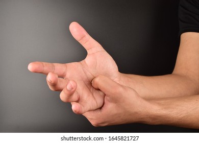 Man Doing Self Acupressure On Dark Background