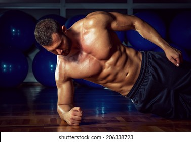 Man Doing Side Plank Exercise In Gym