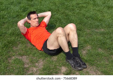 Man Doing Situps On The Grass