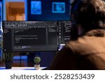 Man doing software quality assurance, reading source code on computer screen before implementing it. Developer inspecting coding on desktop PC, looking to fix potential issues
