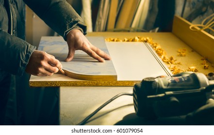 Man doing some carpentry work in a workshop.  - Shutterstock ID 601079054