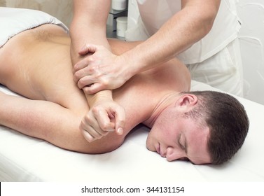 Man Doing Sports Massage At The Massage Parlor