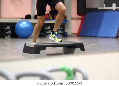 Man doing step up jumps in health club