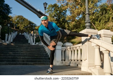 Man doing stretching routine before running up stairs