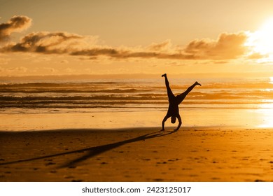 Man Doing Sunset Handstand on Beach