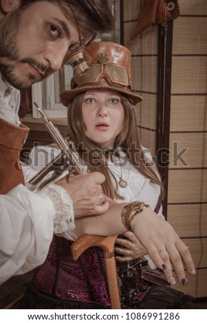 A man is doing a tattoo for a woman, steampunk style