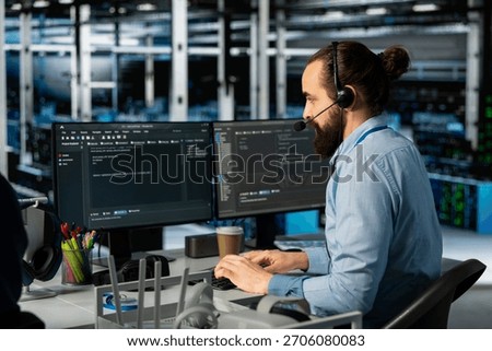 Man doing tech support in server room, managing large scale IT infrastructure rackmounts. Data center admin speaking in headset mic, deploying servers and doing maintenance on network hardware