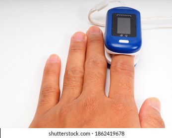 A Man Doing Test Using Pulse Oximeter To Check Oxygen Levels In The Blood