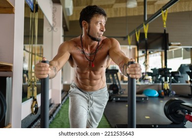 Man Doing Traction Exercises Dragging Weights In A Gym