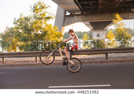 Similar – Image, Stock Photo Two men having fun riding bike and skateboard