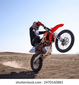 Man doing a Wheelie on a Dirt Bike in the Desert of Colorado - Powered by Shutterstock