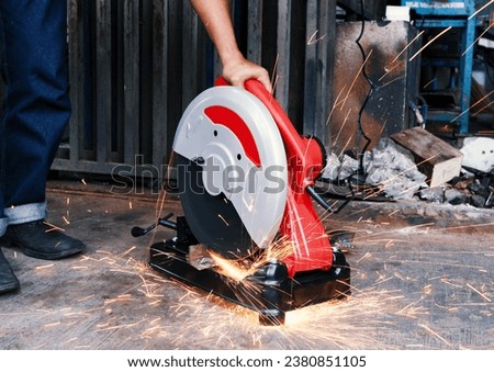 A man is doing work using an CutOff Machine