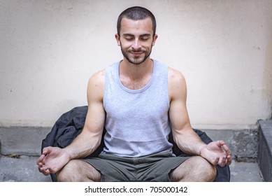 Man Doing Yoga On A Lazy Bag Outside His Home