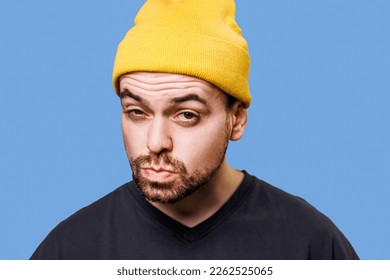A man with a doubtful expression, his facial features twisted into a funny grimace, captured in a studio shot while looking at the camera. Anxiously Enchanted A Studio Shot of a Man's Fascination
