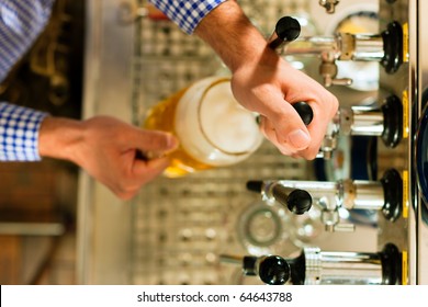 Man Drawing A Beer From Tap On A Kegerator In Pub Or Inn