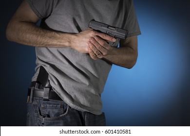 Man Drawing A Conceal Carry Pistol From A Holster