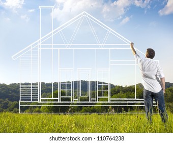Man Drawing A House Blueprint In Nature