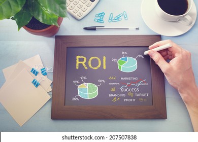 Man drawing ROI concept on chalkboard (return on investment) - Powered by Shutterstock