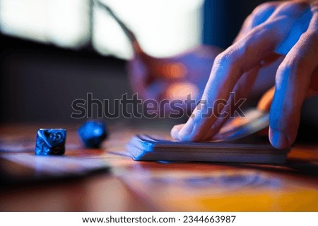 A man drawing trading card game from a deck on a table