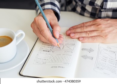 Man draws a sketch graphic design for website

