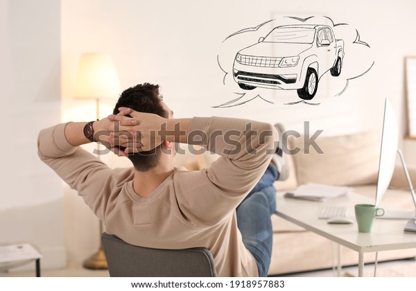Man\
dreaming about new car in office during\
break