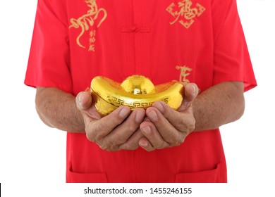 Man Dress In Cheongsam With Chinese Calligraphy “Achieve Immediate Success” And “Good Luck”.
Hands Holding Chinese Gold Ingot.