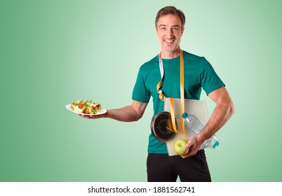 Man Dressed In Sportswear With Meter Scale And Water And Salad Plate On Green Isolated Gradient Background