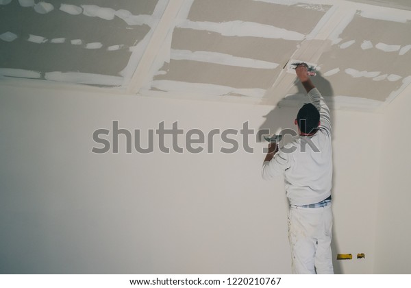 Man Dressed White Painter Applying Putty Stock Photo Edit Now