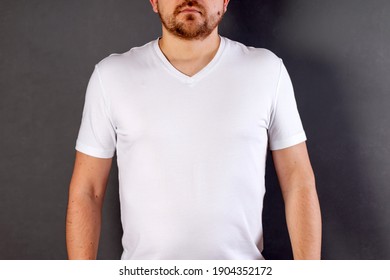 Man Dressed In A White Shirt Isolated On Gray Background With Copy Space