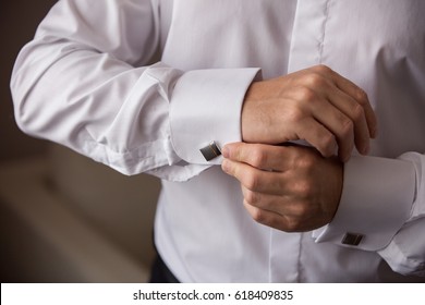 Man Dresses Shirt With Cuff Links