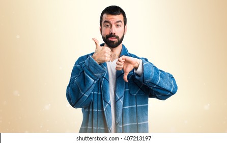 Man In Dressing Gown Making Good-bad Sign