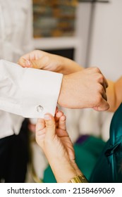 Man Dressing With The Help Of A Woman