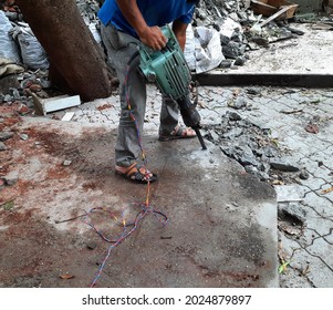 Man Drilling Cement Concrete Using Jack Hammer With Selective Focus