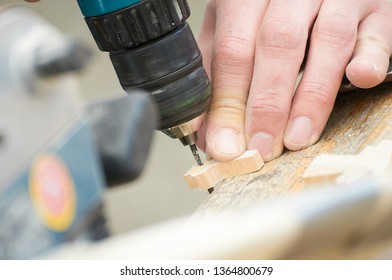 Man Drilling A Piece Of Wood