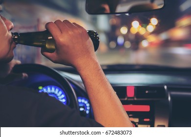 Man Drink Beer While Driving At Night In The City Dangerously, Left Hand Drive System