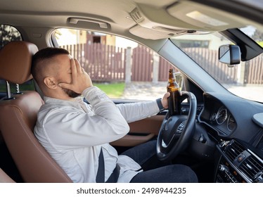 man drinking alcohol while driving the car. Don't drink and drive concept. 